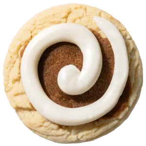 Cinnamon Roll Cookie topped with a rich cinnamon-sugar swirl and thick white cream cheese frosting on a soft golden cookie base.